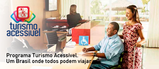 Homem em cadeira de rodas e mulher, sorrindo, são atendidos em balcão de hotel. Logomarca Turismo Acessível, e a frase ‘Programa Turismo Acessível. Um Brasil onde todos podem viajar.